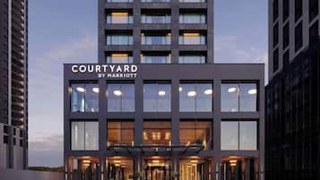 A modern building with a sign reading 'COURTYARD BY MARRIOTT.'