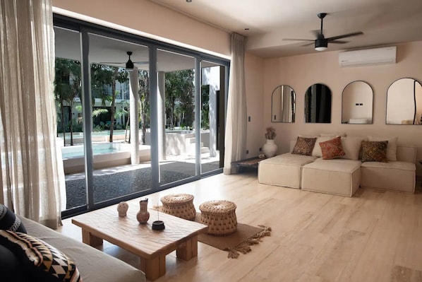 Luxury Apartment, 3 Bedrooms, Private Pool, Park View (Attha A1) | Living area | 55-inch Smart TV with digital channels, Netflix, books - BT Homes - Wellness Jungle (Tulum)