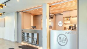 Ein Empfangsbereich mit Rezeption, einer Minibar und einer Kaffeemaschine.