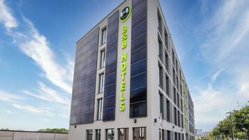 A modern hotel building with a prominent sign for 'B&B HOTELS'.