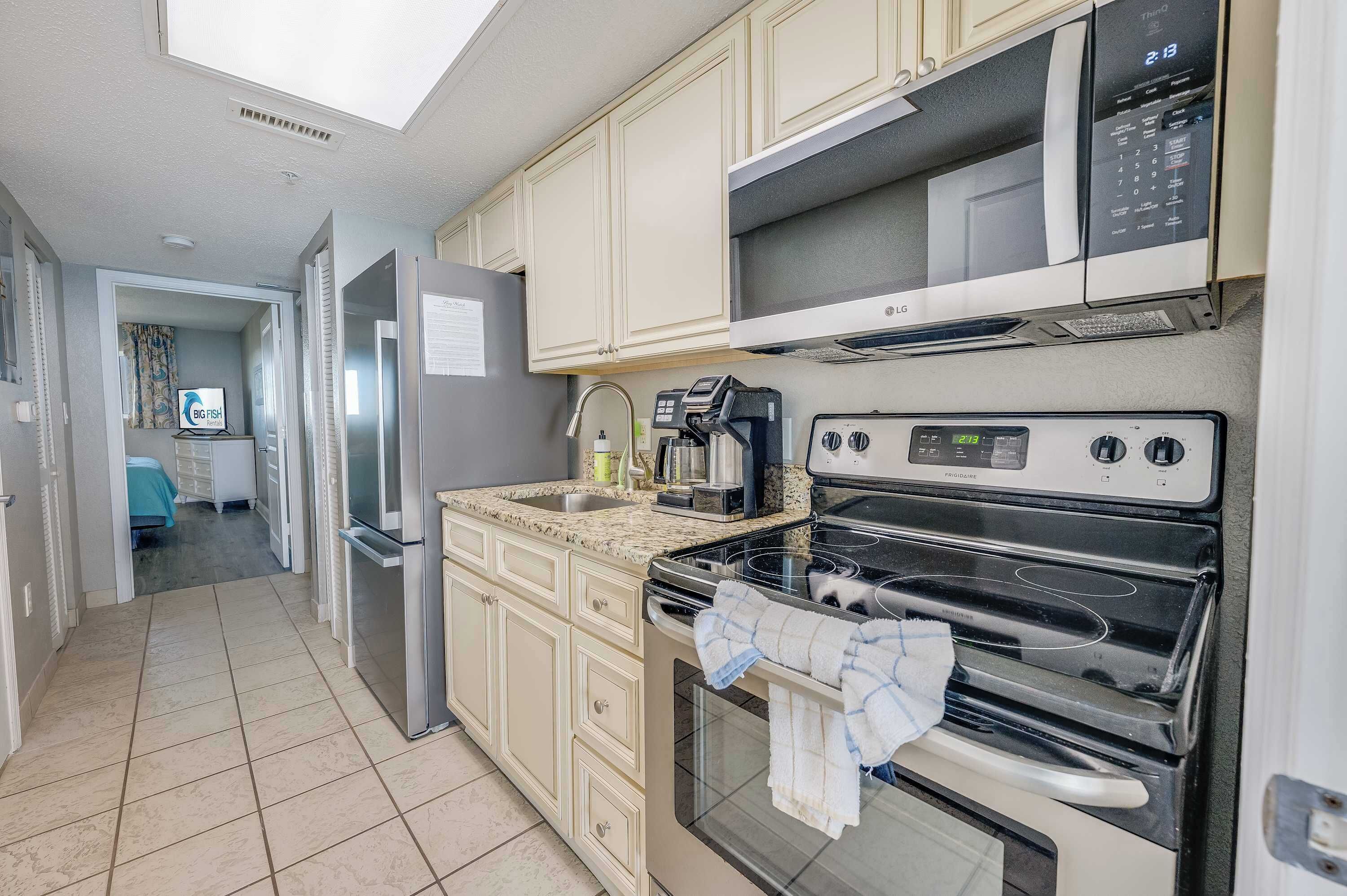 A kitchen with a microwave, stove, and refrigerator.