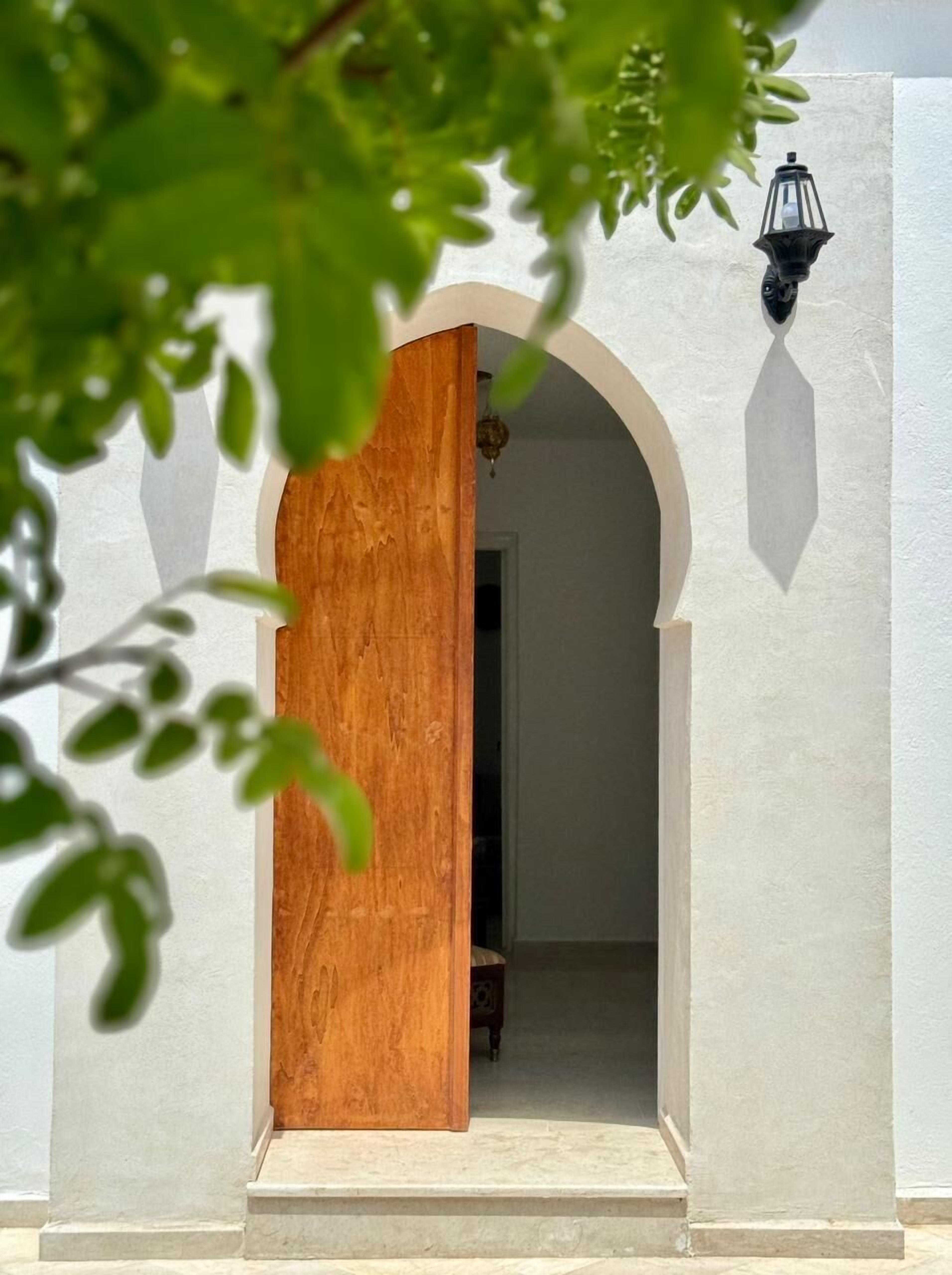 A doorway with a wooden archway leading into a room.