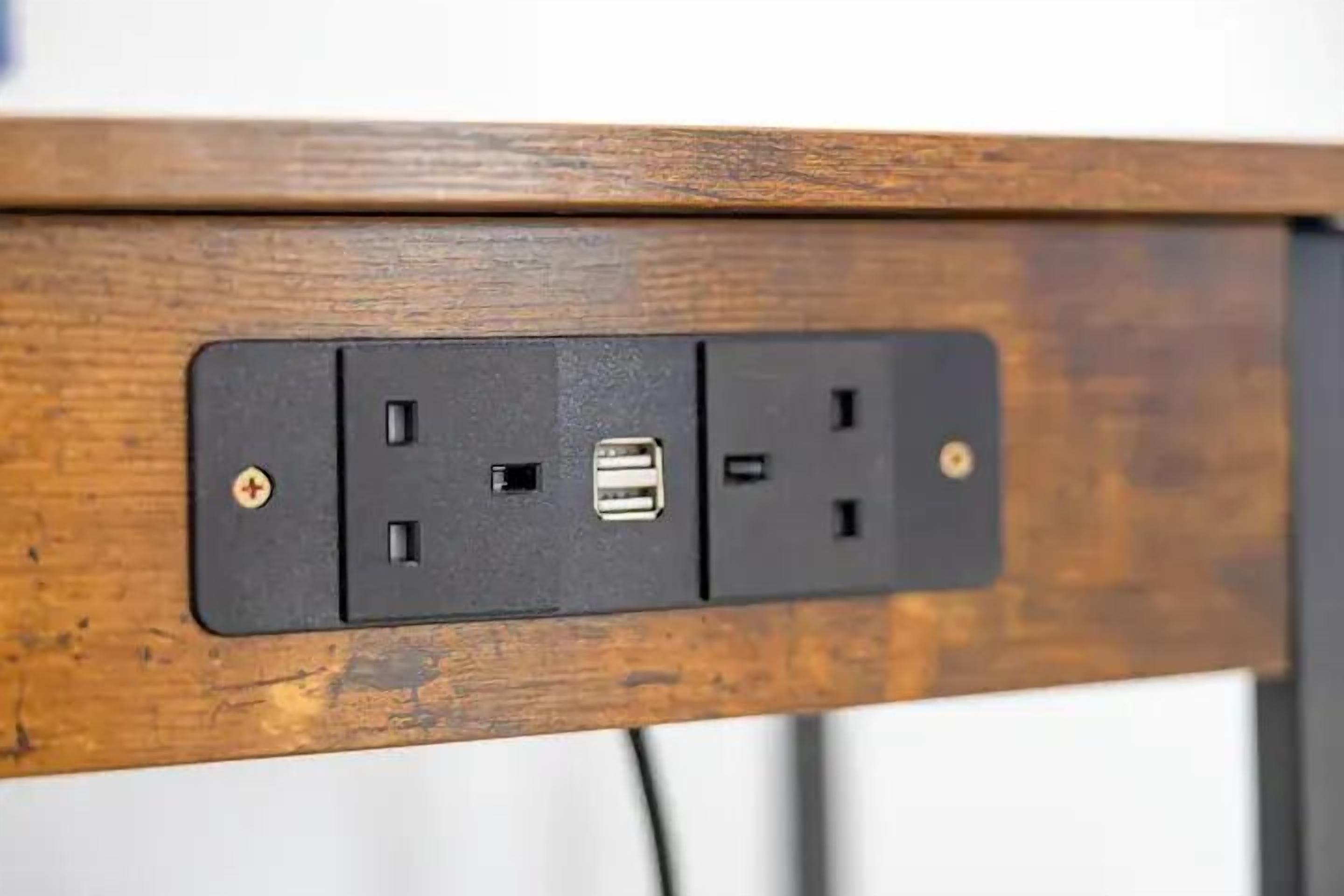 A wooden surface with a black electrical outlet and USB port.