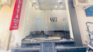 A hotel entrance with a sign reading "SURYA INTERNATIONAL" and a staircase leading inside. - Hotel Surya International (New Delhi)