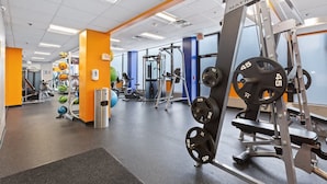 A gym with various exercise equipment, including weight machines and free weights.
