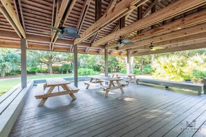 An outdoor wooden deck with picnic tables and ceiling fans. - 255 Turnberry-Fazio Course Views, Dog Friendly, Free Tennis (Hilton Head Island)