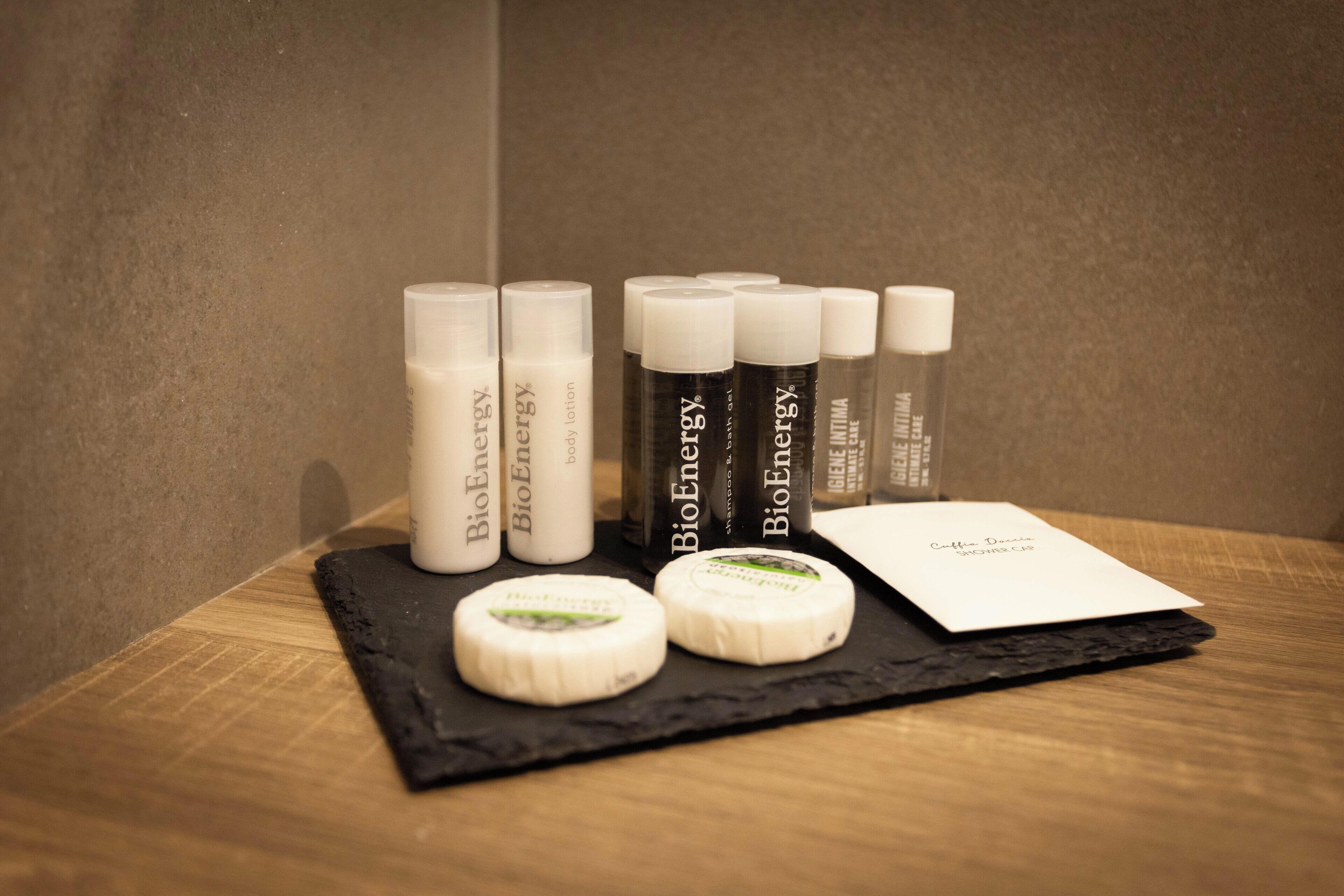 A display of BioEnergy products including bottles and cheese on a wooden surface.