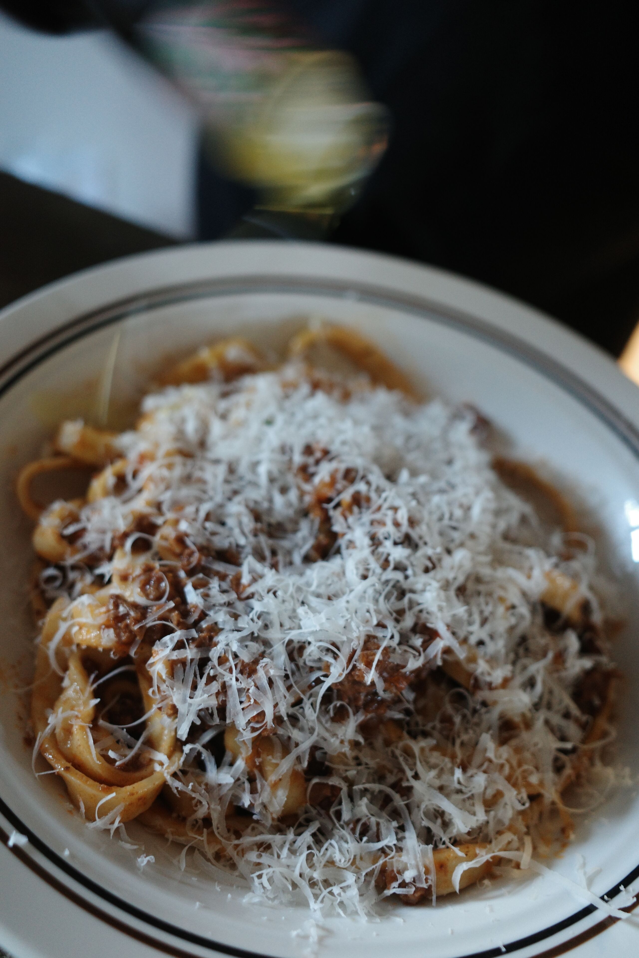 A bowl of pasta with cheese.