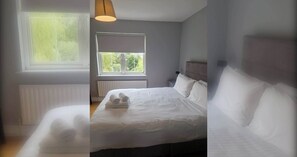 A bedroom with a bed, a window, a radiator, and a lamp. - Large 3BD Duplex, 20Min to Airport (Dublin)