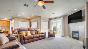 A spacious living room with a leather sofa, a recliner, and a fireplace. - Pool Access & Patio! Resort-style St George Condo (St. George)