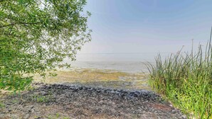 A natural landscape with a body of water, vegetation, and a clear sky. - Lakefront Chiloquin Home w/ Scenic Deck! (Chiloquin)