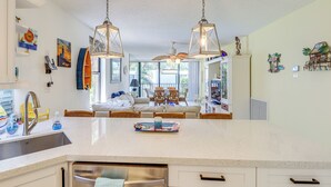 A kitchen with a large island, stainless steel appliances, and pendant lighting. - Key Largo Condo - Community Pool, Marina & Beach! (Key Largo)