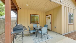 An outdoor patio with a grill, table, and chairs. - Family-friendly Florence Home: 3 Mi to the Coast! (Florence)