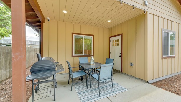An outdoor patio with a grill, table, and chairs. - Family-friendly Florence Home: 3 Mi to the Coast! (Florence)