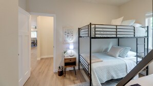 A bunk bed room with a desk, a lamp, and a framed picture on the wall. - Family-friendly Florence Home: 3 Mi to the Coast! (Florence)