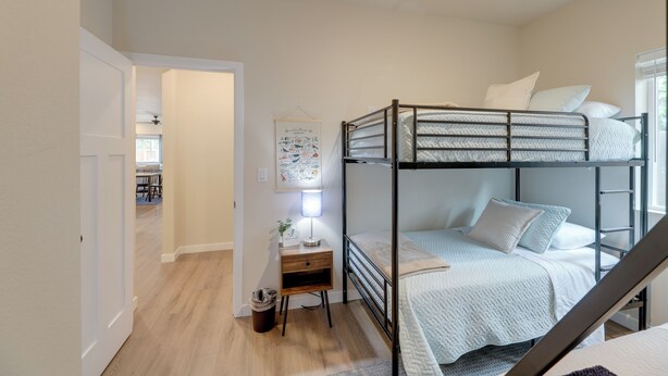 A bunk bed room with a desk, a lamp, and a framed picture on the wall. - Family-friendly Florence Home: 3 Mi to the Coast! (Florence)