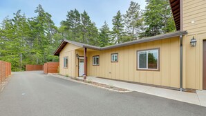 A two-story house with a front porch, a garage, and a driveway. - Family-friendly Florence Home: 3 Mi to the Coast! (Florence)