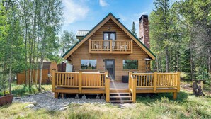 A wooden cabin with a balcony, surrounded by trees. - 24str-00023 Fairplay Cabin w/ Hot Tub on 4 Acres! (Fairplay)