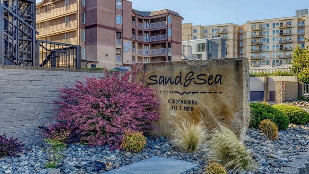 A sign for 'sand&sea' condos with a price of $475 per month. - Sand & Sea (310) Driftwood - Oceanfront Pet Friendly (Seaside)