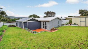 A residential property with a garage, a covered outdoor area, and a well-maintained lawn. - 91 On the Rocks 91 Port Elliot Rd Hayborough Chiton (Hayborough)