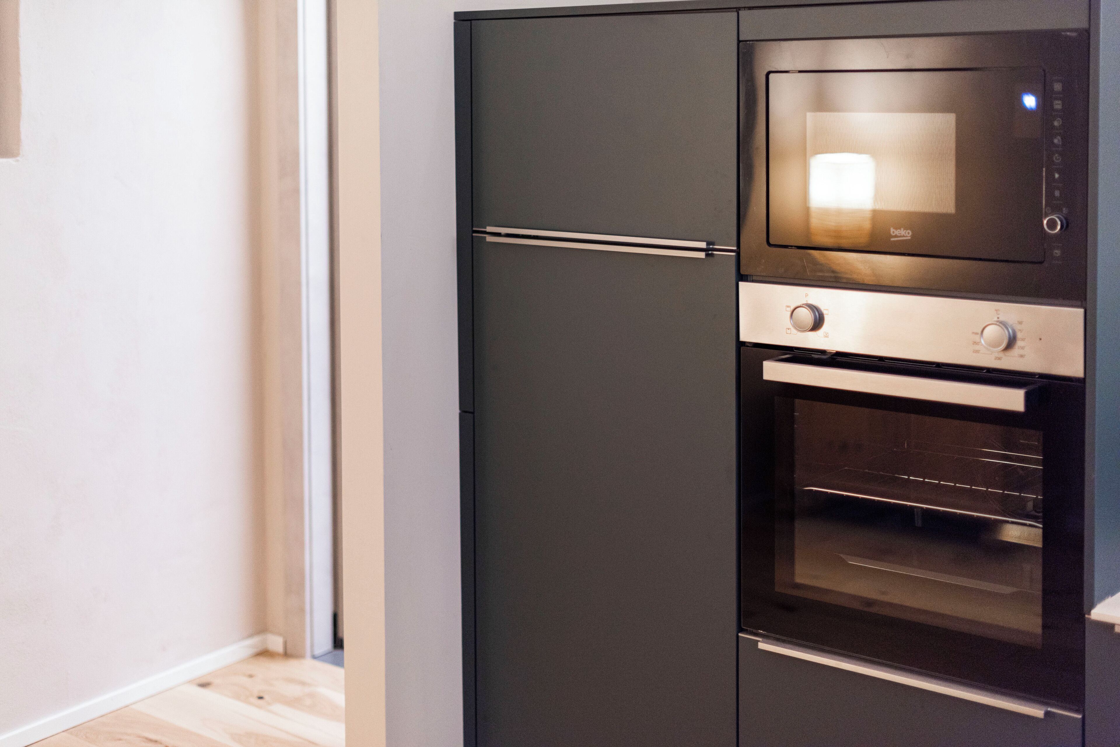 Une cuisine moderne dotée d’un four et d’un micro-ondes encastrés.