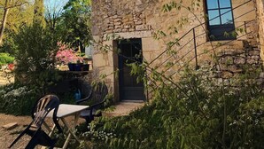 A stone building with a tiled roof, a small tower, and a window. - Château de Belmont Ste Foi - a place steeped in history ! (Belmont-Sainte-Foi)
