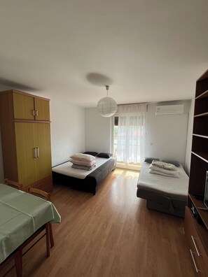 Cozy retreat with two single beds, a wardrobe, and a TV.