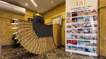 A reception desk with a large display of Egypt-themed photos and hieroglyphics.
