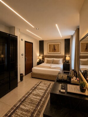 A modern hotel room with a large bed, bedside tables, a desk with a mirror, a small rug, and a large window. - Taj pyramids view inn (Giza)