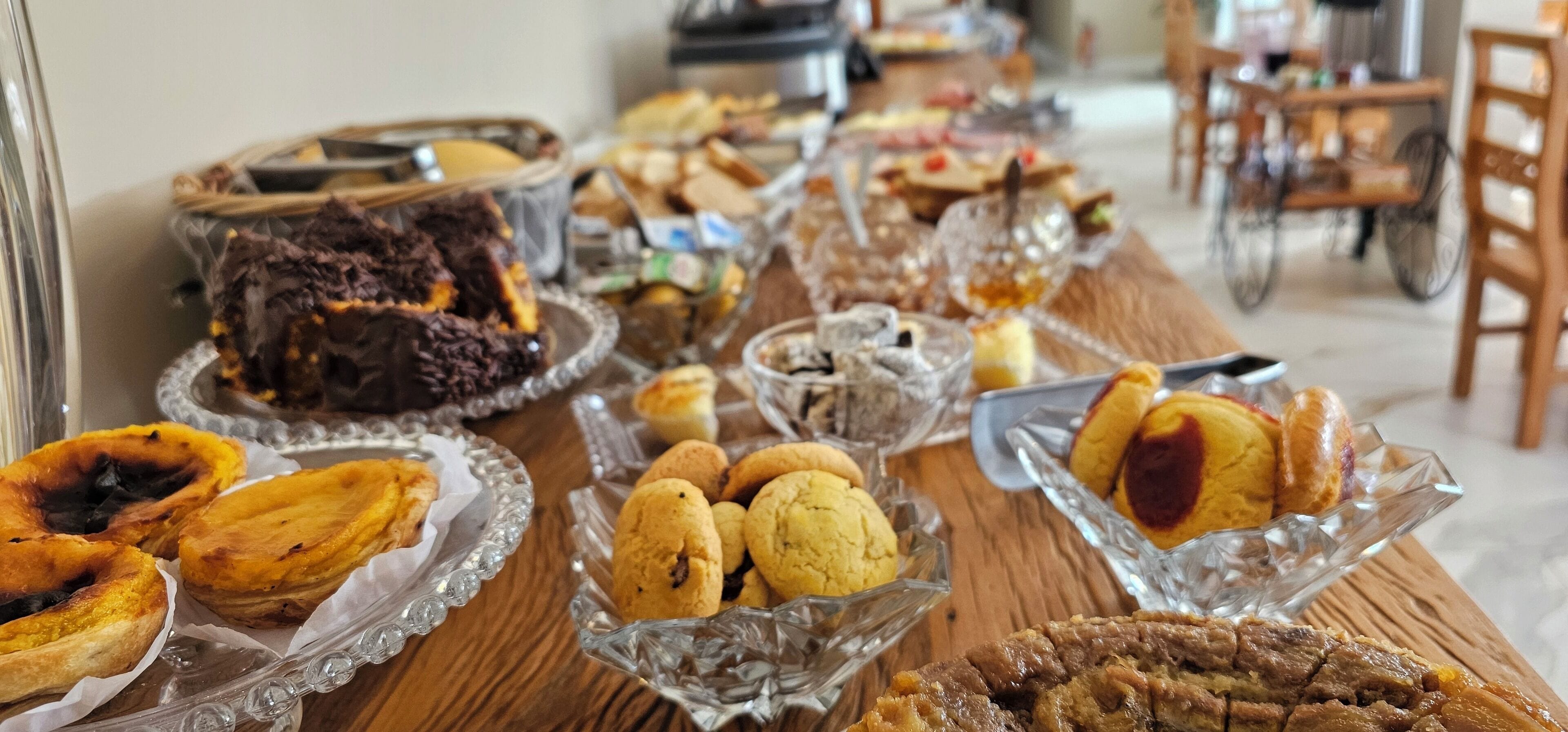 A buffet table with various baked goods and desserts.