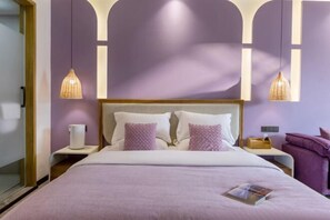 A hotel room with a bed, two bedside tables, a nightstand, a chair, and pendant lights. - The Valley of Flowers (Lijiang)