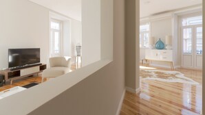 A modern living room with a flat-screen TV, a white sofa, and a wooden floor. - Andrade in Lisboa Ciudad (Lisbon)