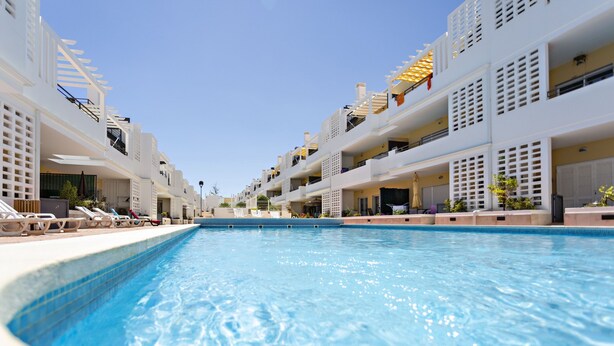 A swimming pool with white buildings on either side.