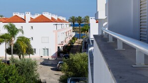 A residential building with a red-tiled roof, white walls, and a balcony with a railing. - Formosa Bay - HB in Tavira (Tavira)