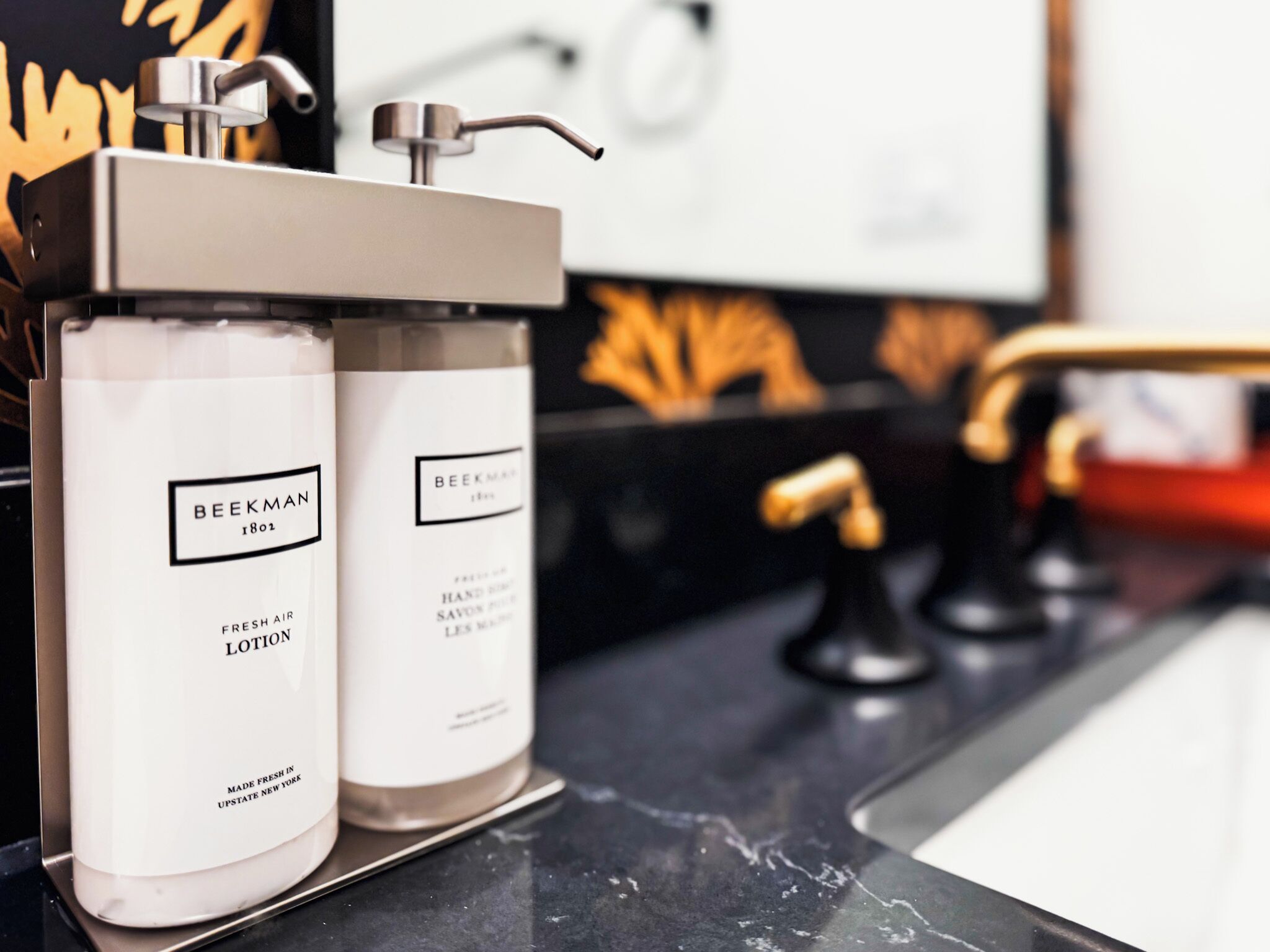 Two bottles of Beckman lotion on a marble countertop.