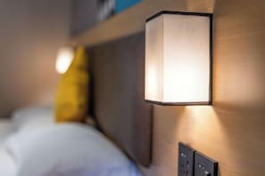 A wall-mounted light fixture with a rectangular shape and a visible switch below it.