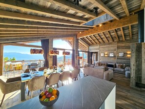 A spacious room with a large dining table, comfortable seating, and a view of the mountains. - Appartement B-03 T2 Cabine (Font-Romeu-Odeillo-Via)
