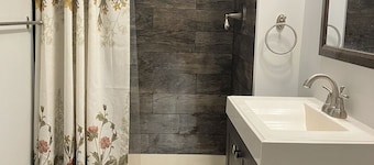 Large Furnished Basement Studio with Bathroom, WiFi, AC, and Parking in Stamford