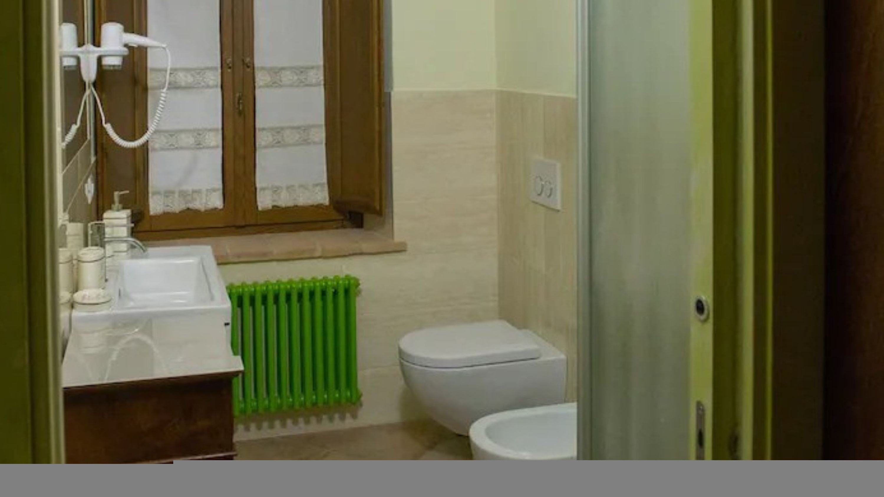 Ein kleines Badezimmer mit Waschbecken, Toilette und Dusche.