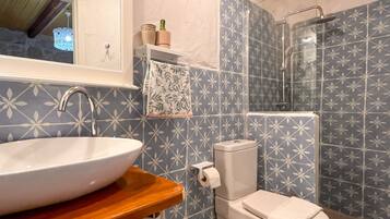 Shower, slippers, towels, toilet paper