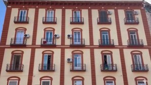 A multi-story building with a consistent architectural style, featuring balconies and windows. - Nerisa Home (Napoli)