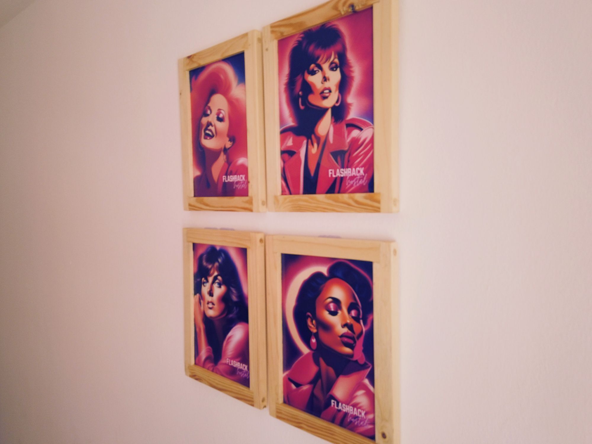 Four framed posters on a wall.