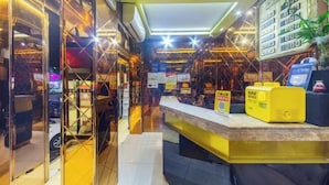A modern hotel lobby with a reception desk, glass partitions, and a digital display board. - Changsheng Hotel (Nanjing)
