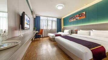A hotel room with two beds, a desk, a TV, and a painting on the wall.