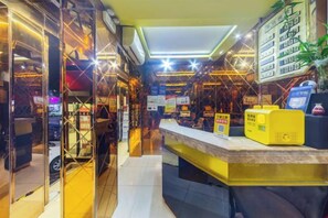 A hotel lobby with a reception desk, a seating area, and a display of amenities. - Changsheng Hotel (Nanjing)