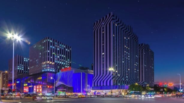 A modern building with a unique architectural design, featuring vertical lines and a prominent entrance. - Changsheng Hotel (Nanjing)