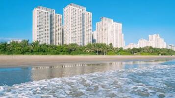 A beachfront with high-rise buildings in the background.