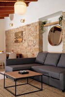 Deluxe Suite | Living area | 32-inch TV with cable channels