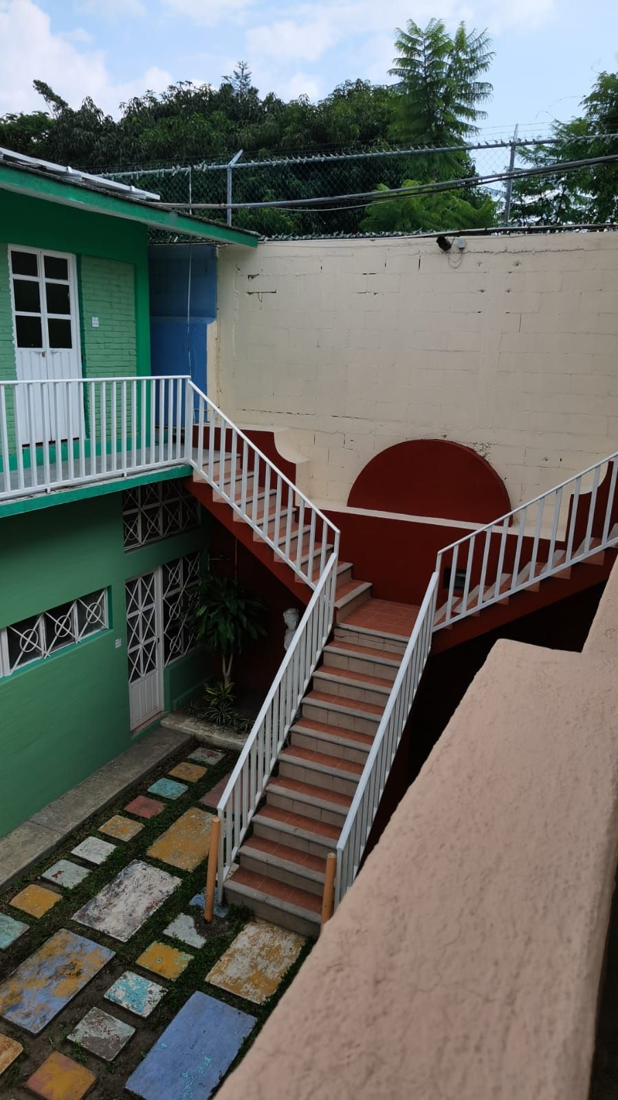 A multi-level building with a staircase connecting the ground floor to the upper floors.