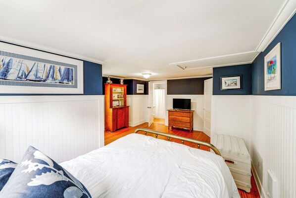 A bedroom with a bed, dresser, and a television. - 2 Mi to Dtwn: 2-Acre Retreat w/ Large Yard! (Madison)